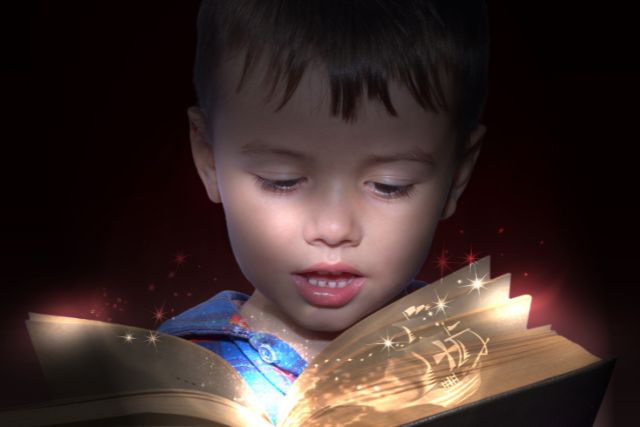a boy reads a book that has some magical elements in it