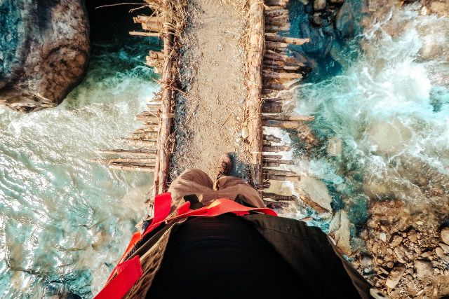 a top-down view of a person crossing a bridge