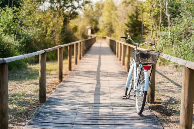 a bike leans against a wooden railing