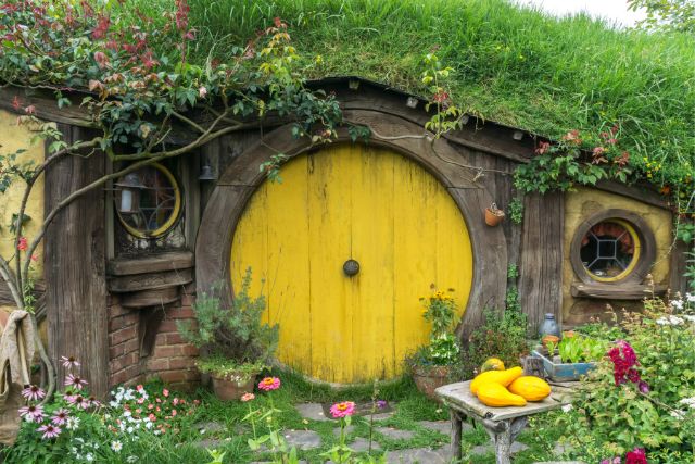 a hobbit house with a yellow door