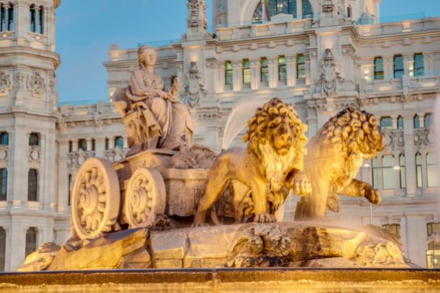 a statue of a woman being pulled in a carriage by two lions