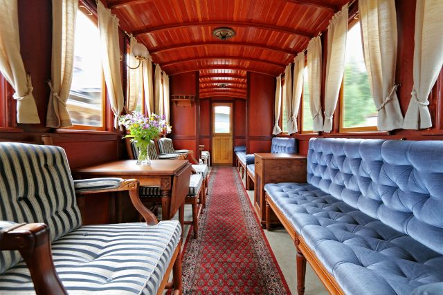 an upscale train car with fancy seats